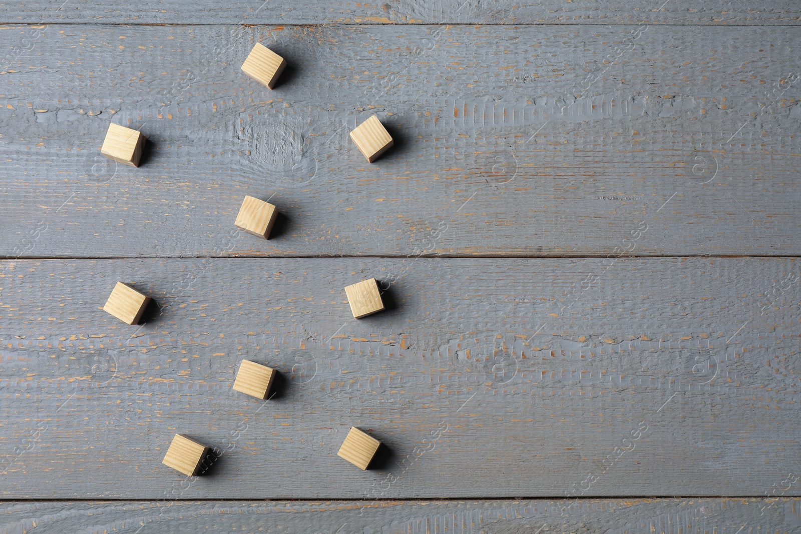 Photo of Blank cubes on light grey wooden table, flat lay. Space for text