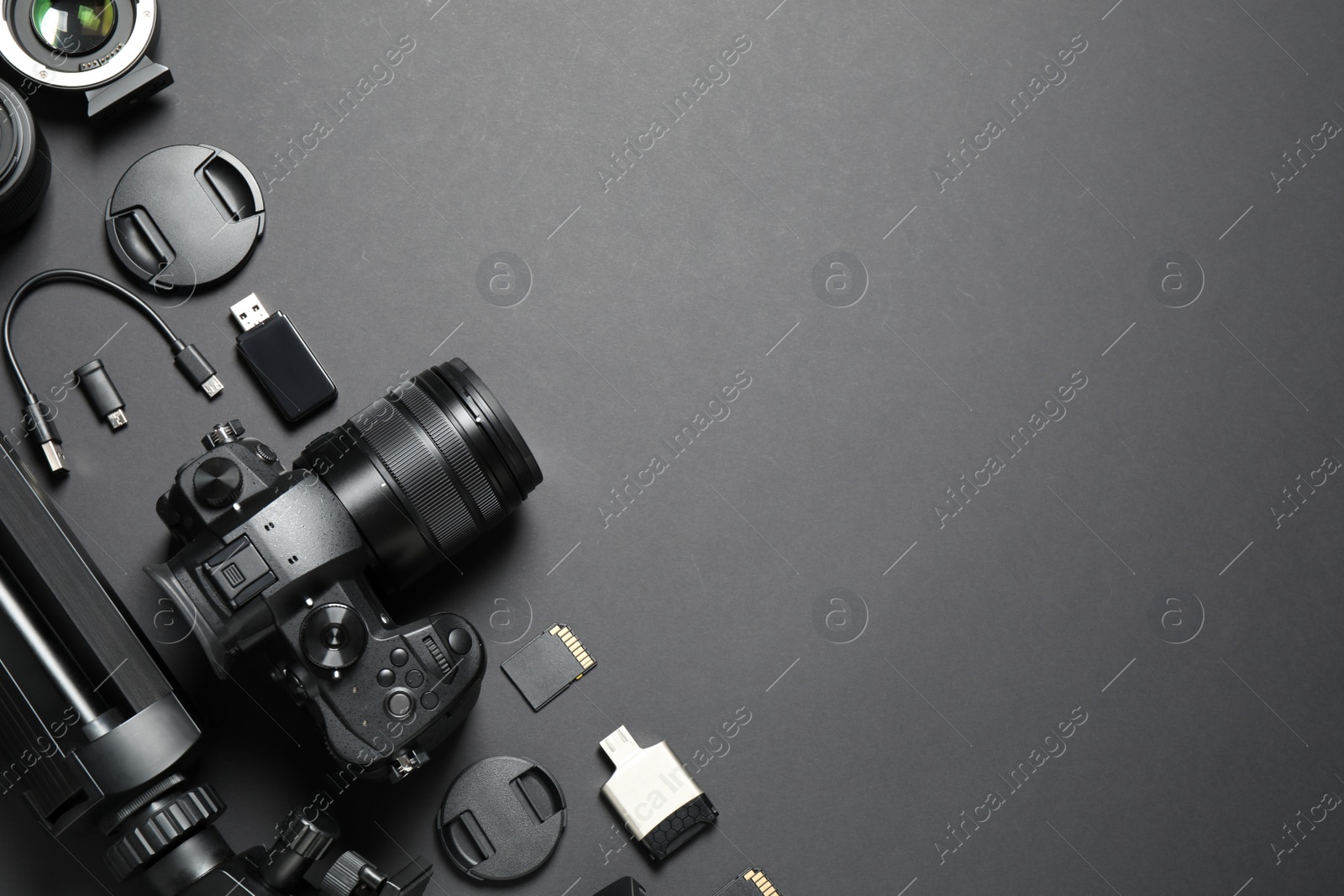 Photo of Flat lay composition with camera and video production equipment on black background. Space for text