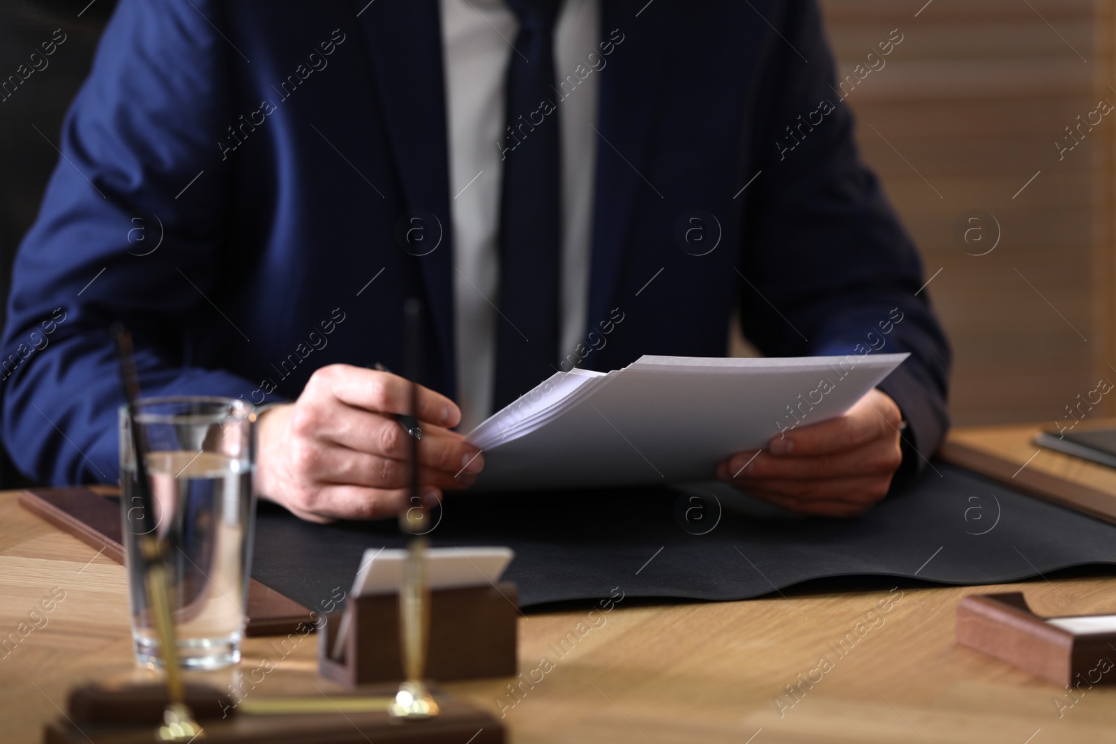 Photo of Male lawyer working at table in office, closeup