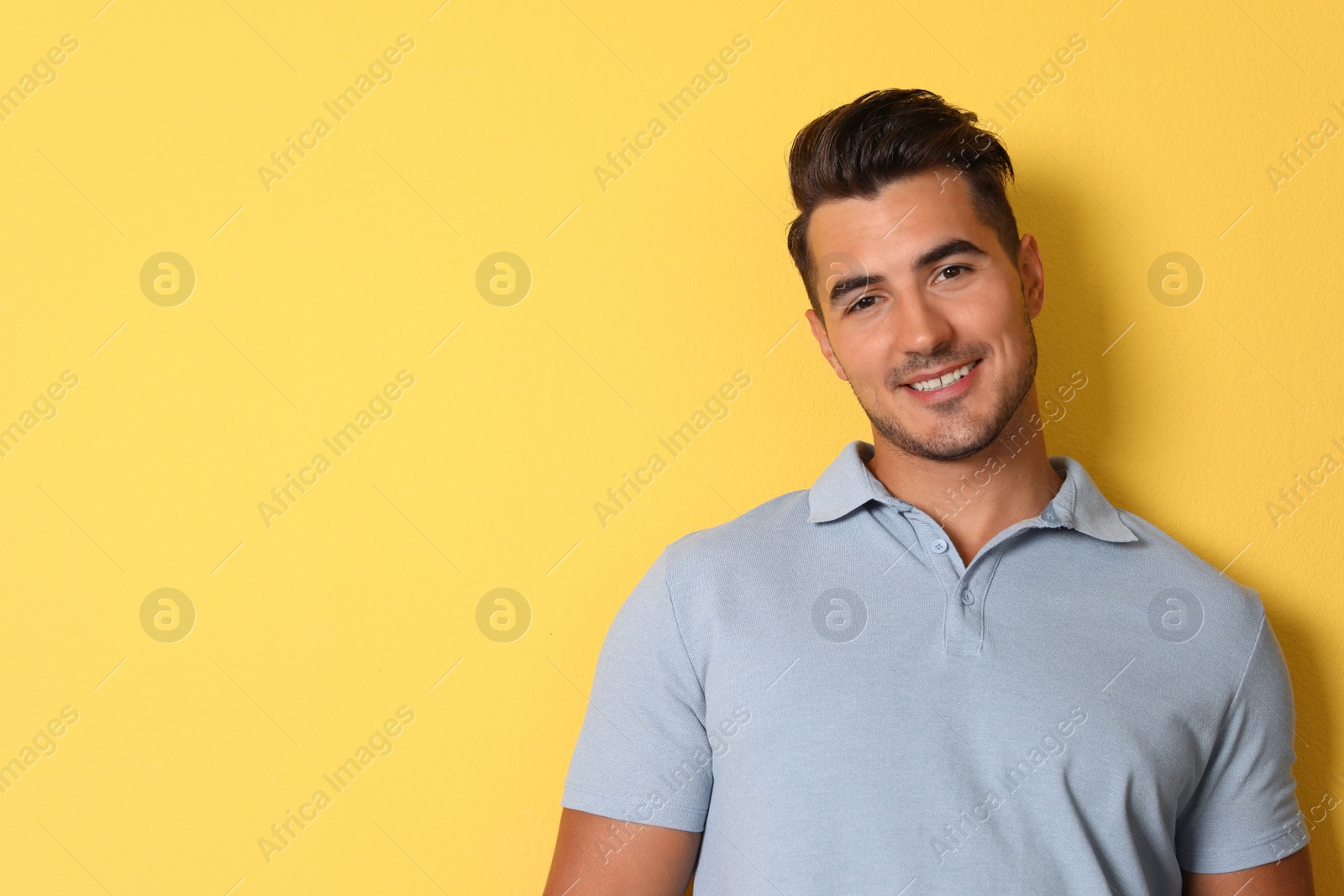 Photo of Portrait of handsome young man and space for text on color background