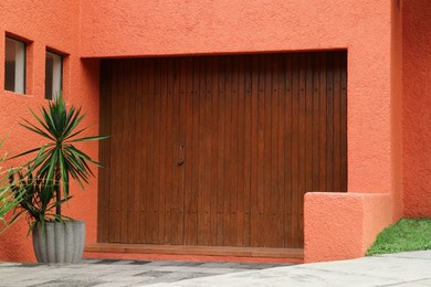 Photo of Beautiful wooden doors on bright building wall