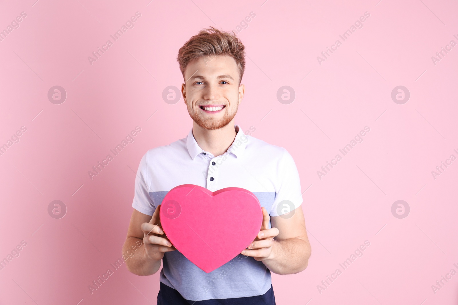 Photo of Portrait of young man with decorative heart on color background