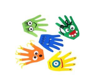 Photo of Funny hand shaped monsters on white background, top view. Halloween decoration