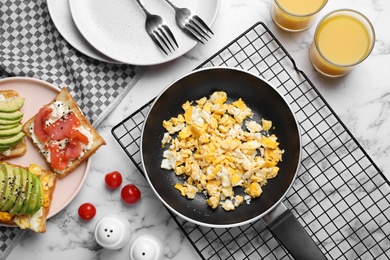 Photo of Delicious breakfast served on white marble table, flat lay