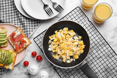 Delicious breakfast served on white marble table, flat lay