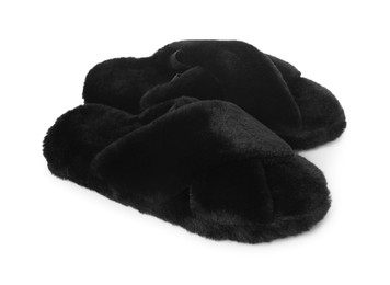 Pair of black fluffy slippers isolated on white