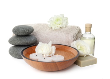 Beautiful spa composition with candles and stones on white background