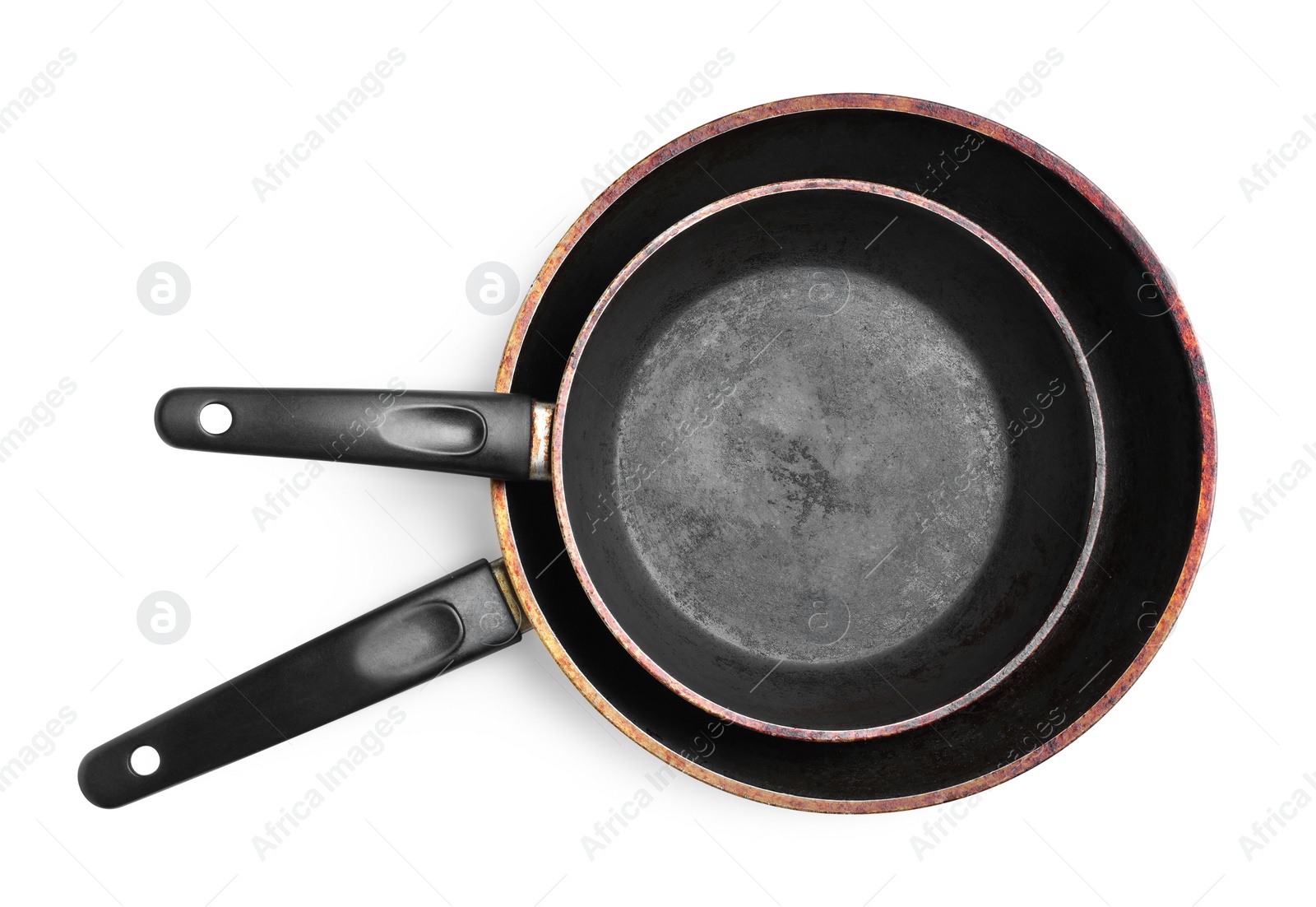 Photo of Dirty old frying pans on white background, top view