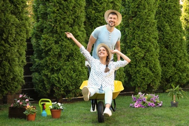 Photo of Happy couple having fun while working together in garden