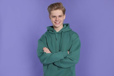 Photo of Portrait of teenage boy on purple background