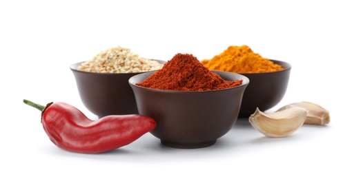 Photo of Different aromatic spices in bowls on white background