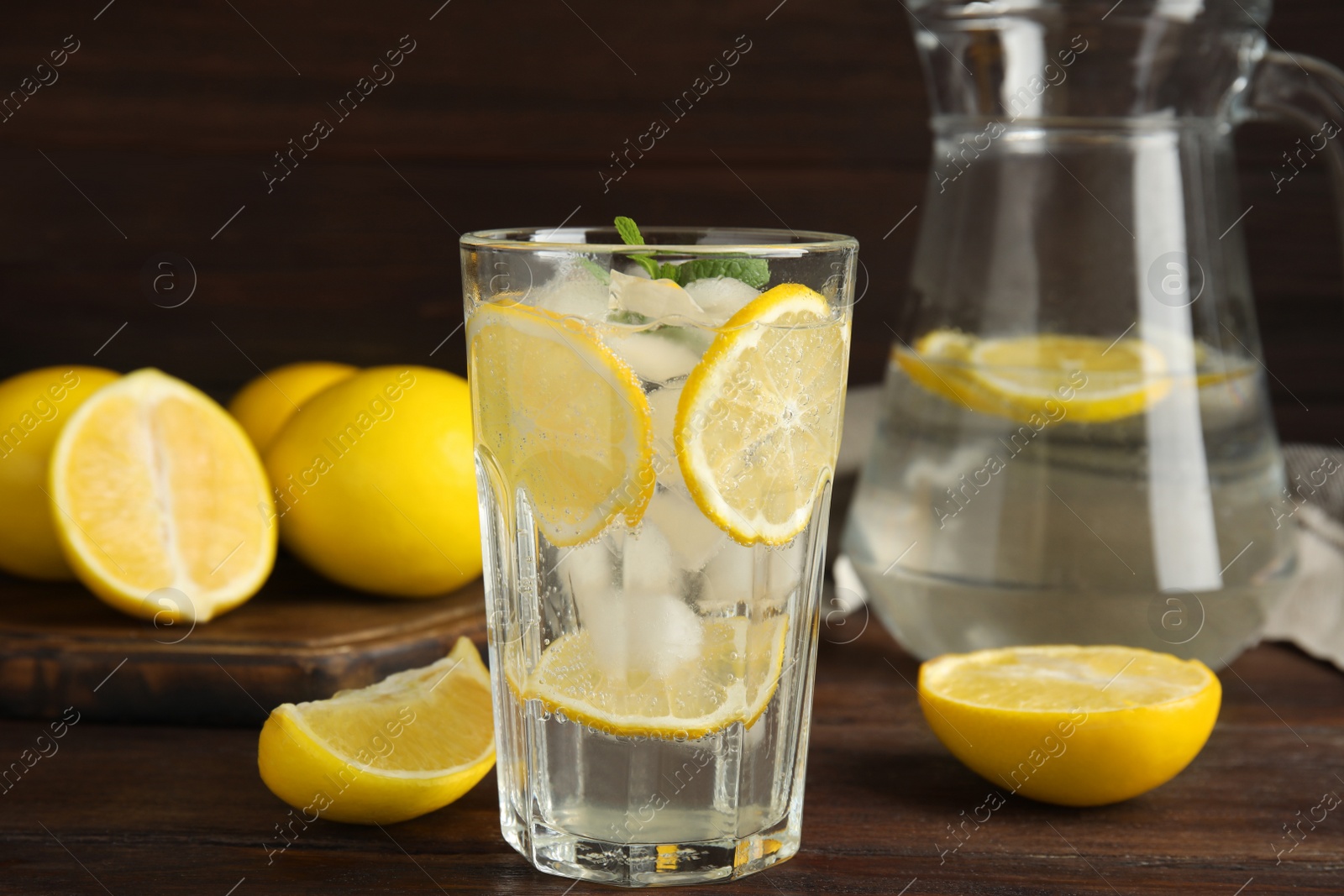 Photo of Cool freshly made lemonade on wooden table