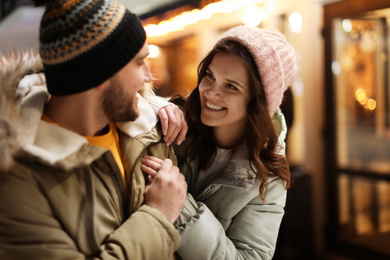 Photo of Lovely couple on city street. Winter vacation