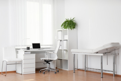 Photo of Interior of modern medical office with doctor's workplace