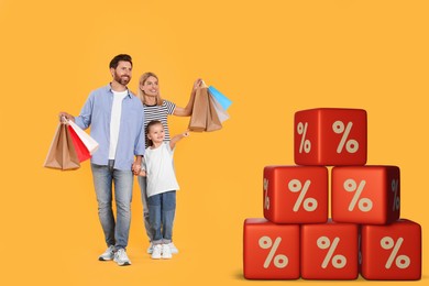 Image of Discount offer. Happy family with paper shopping bags on orange background. Pyramid of cubes with percent signs near them