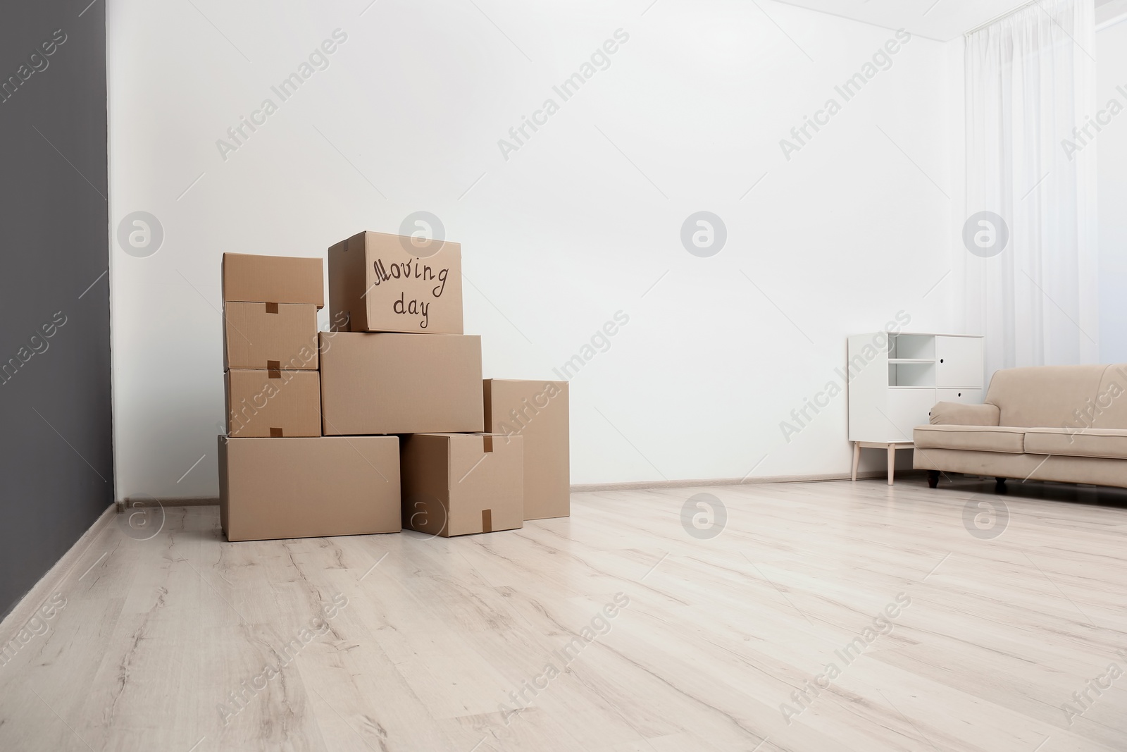 Photo of Pile of moving boxes in empty room