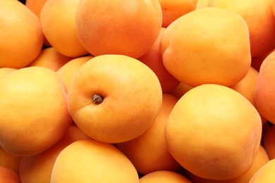 Photo of Delicious ripe sweet apricots as background, closeup view