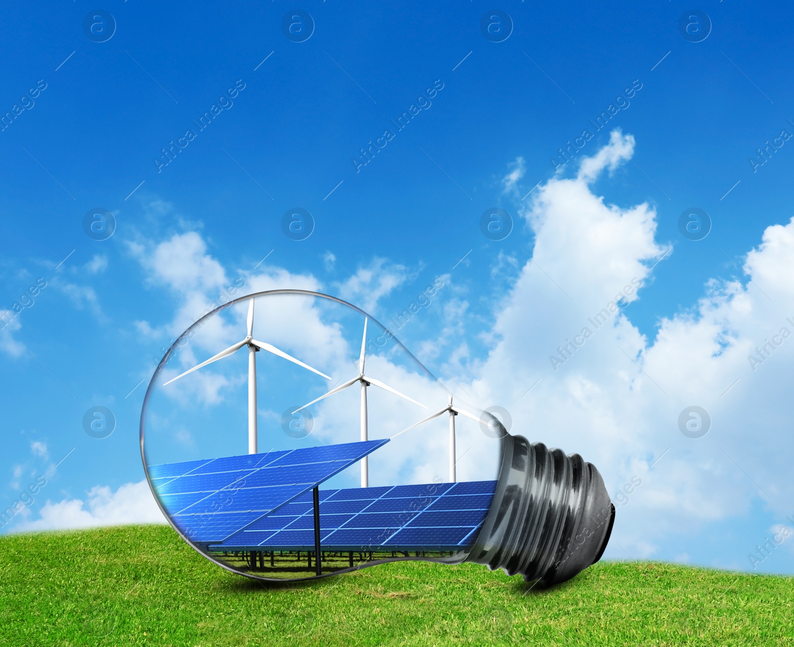 Image of Alternative energy source. Light bulb with solar panels and wind turbines outdoors