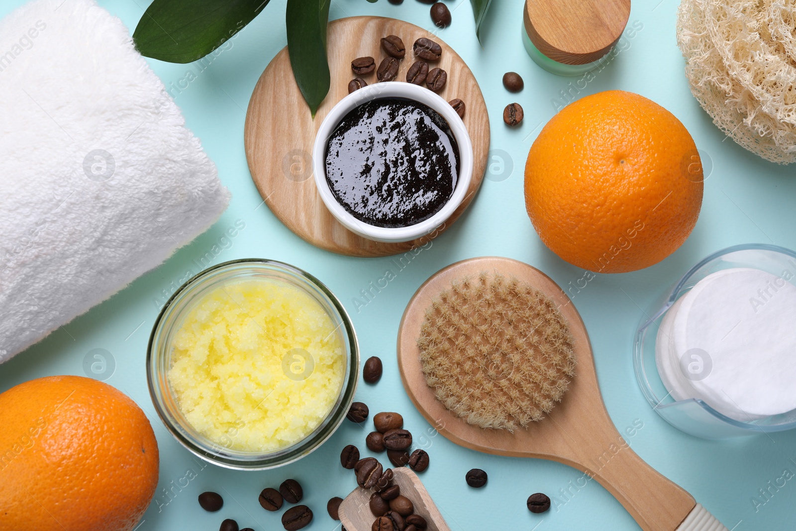 Photo of Flat lay composition with natural body scrubs and fresh ingredients on light blue background. Anti cellulite treatment