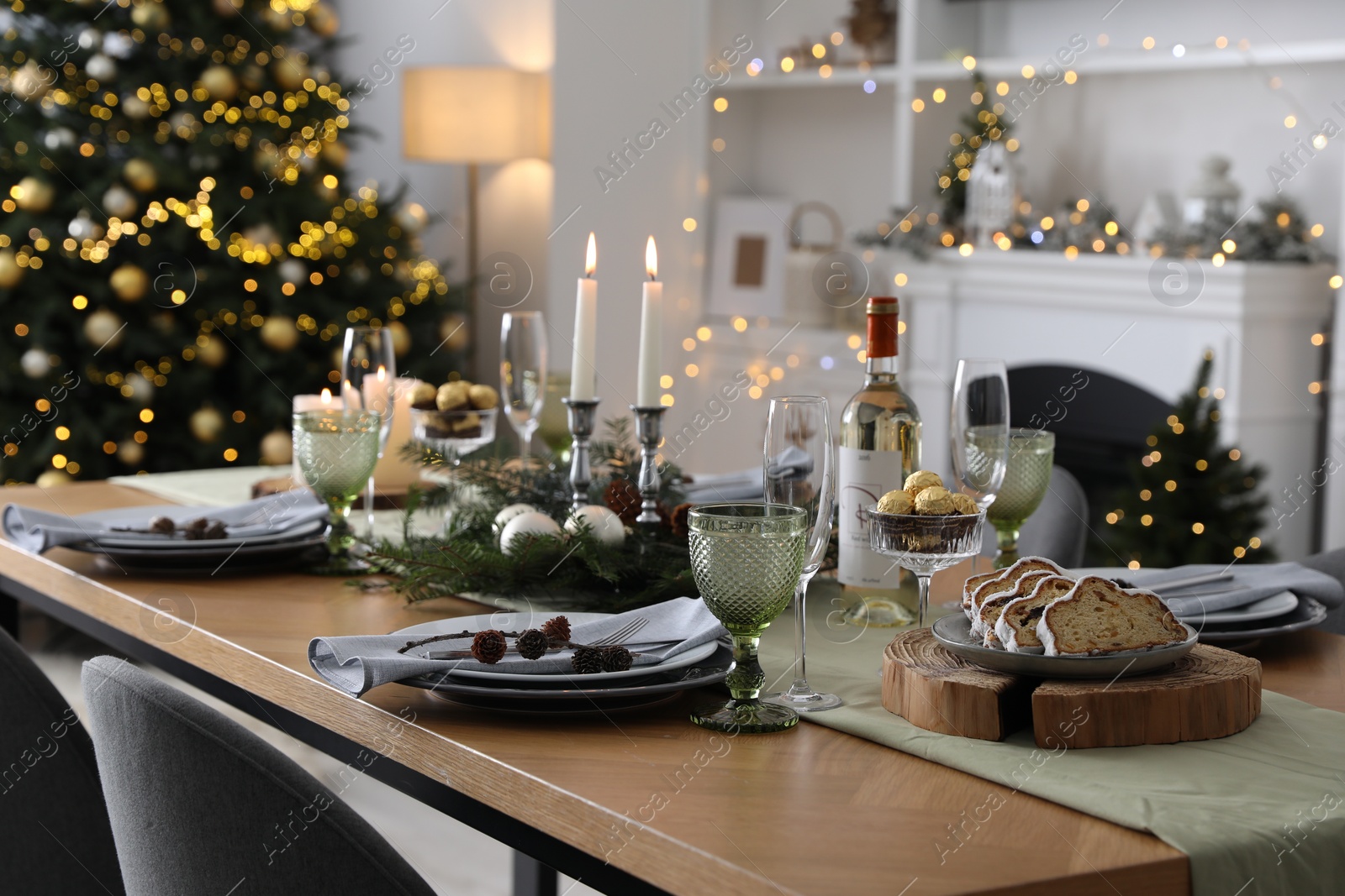 Photo of Christmas table setting with festive decor and dishware in living room