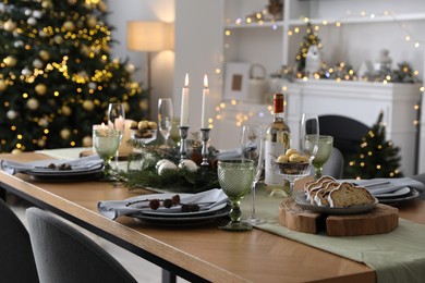 Christmas table setting with festive decor and dishware in living room