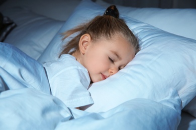 Photo of Beautiful little girl sleeping in bed at night. Bedtime schedule