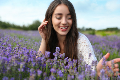 Young woman in lavender field on summer day