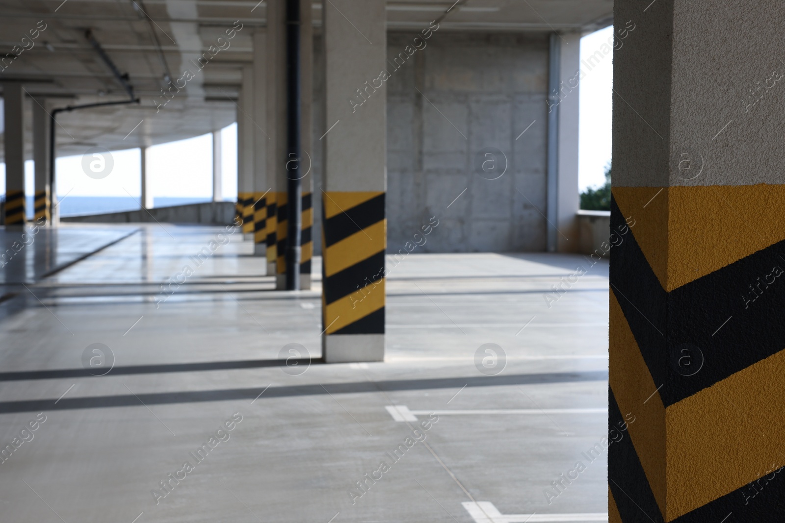 Photo of Empty open car parking garage on sunny day