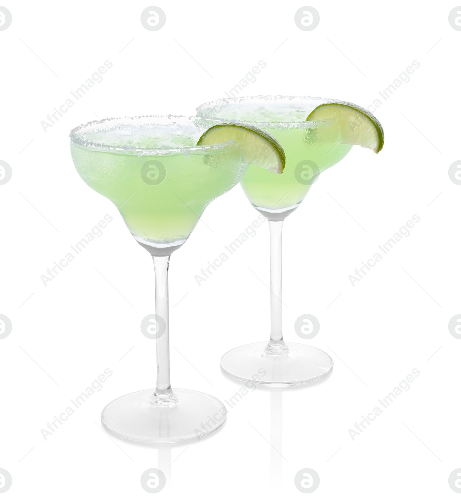 Photo of Delicious Margarita cocktail in glasses, salt and lime isolated on white