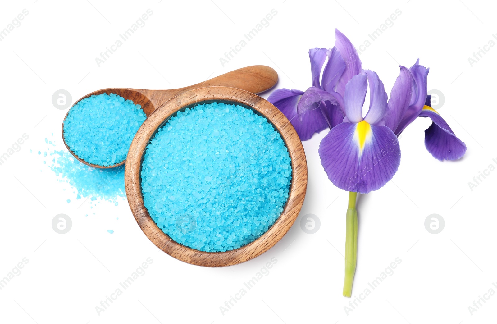 Photo of Light blue sea salt in bowl, spoon and iris flower isolated on white, top view
