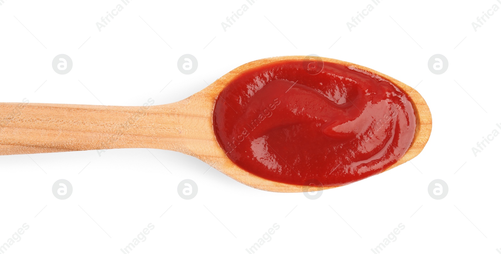 Photo of Wooden spoon with tasty ketchup isolated on white, top view