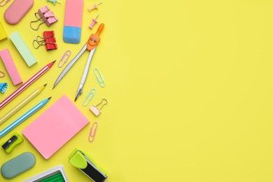 Photo of Flat lay composition with different school stationery on pale yellow background, space for text. Back to school