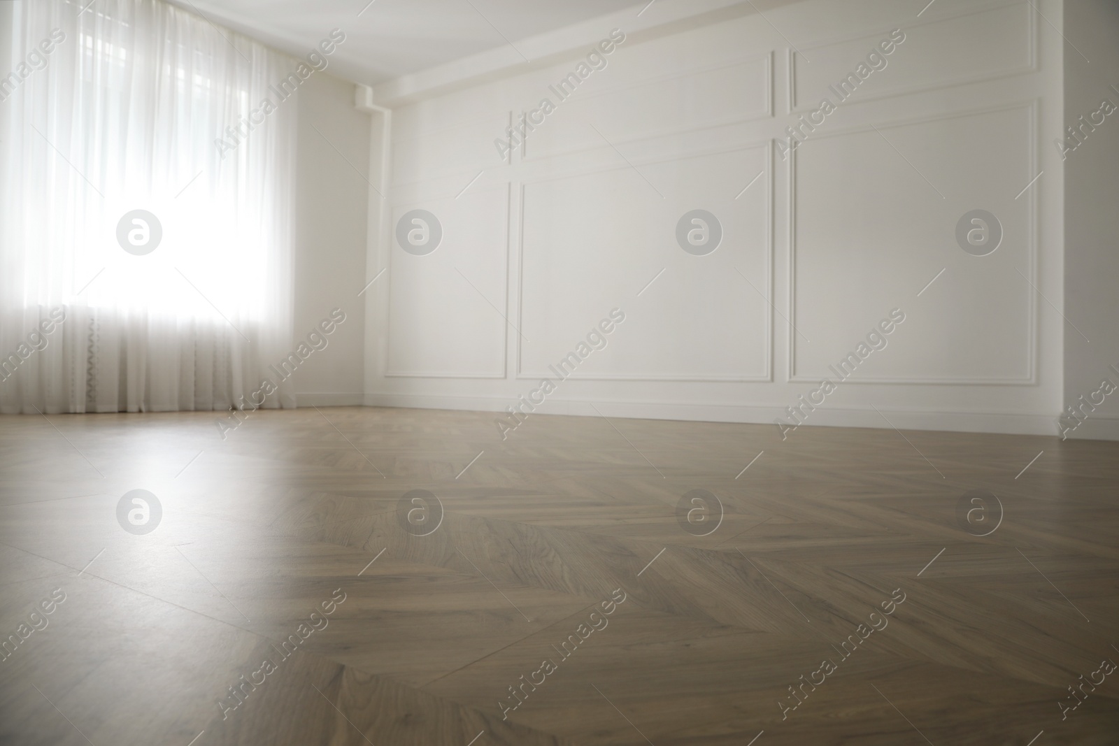 Photo of Parquet floor in light spacious empty room