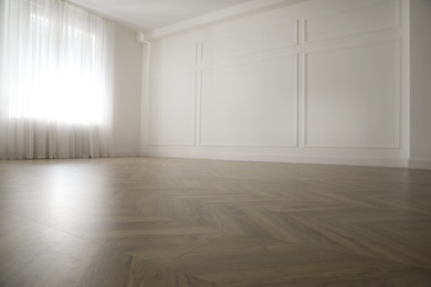 Photo of Parquet floor in light spacious empty room
