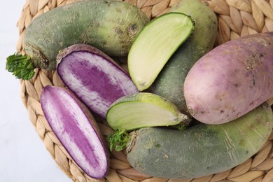 Photo of Green and purple daikon radishes on table, top view