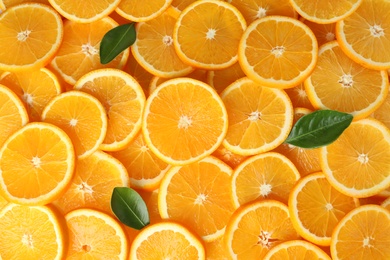 Photo of Many sliced fresh ripe oranges as background, top view