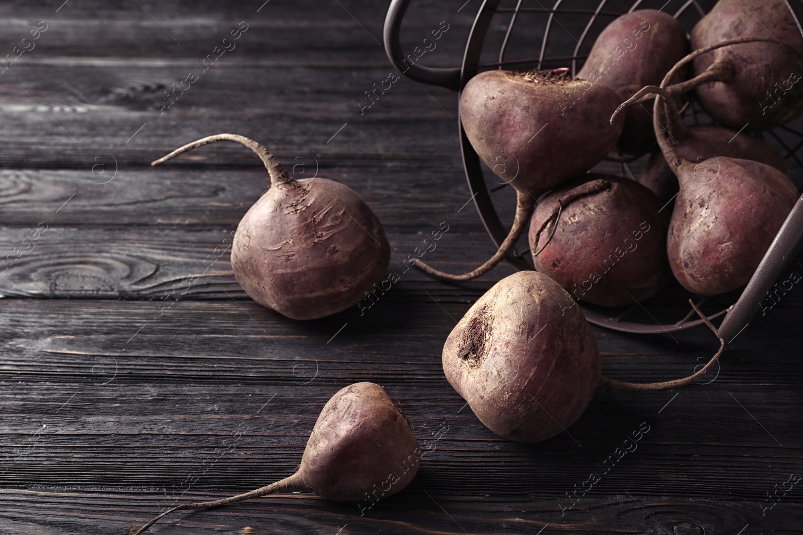 Photo of Basket with whole fresh beets on wooden table