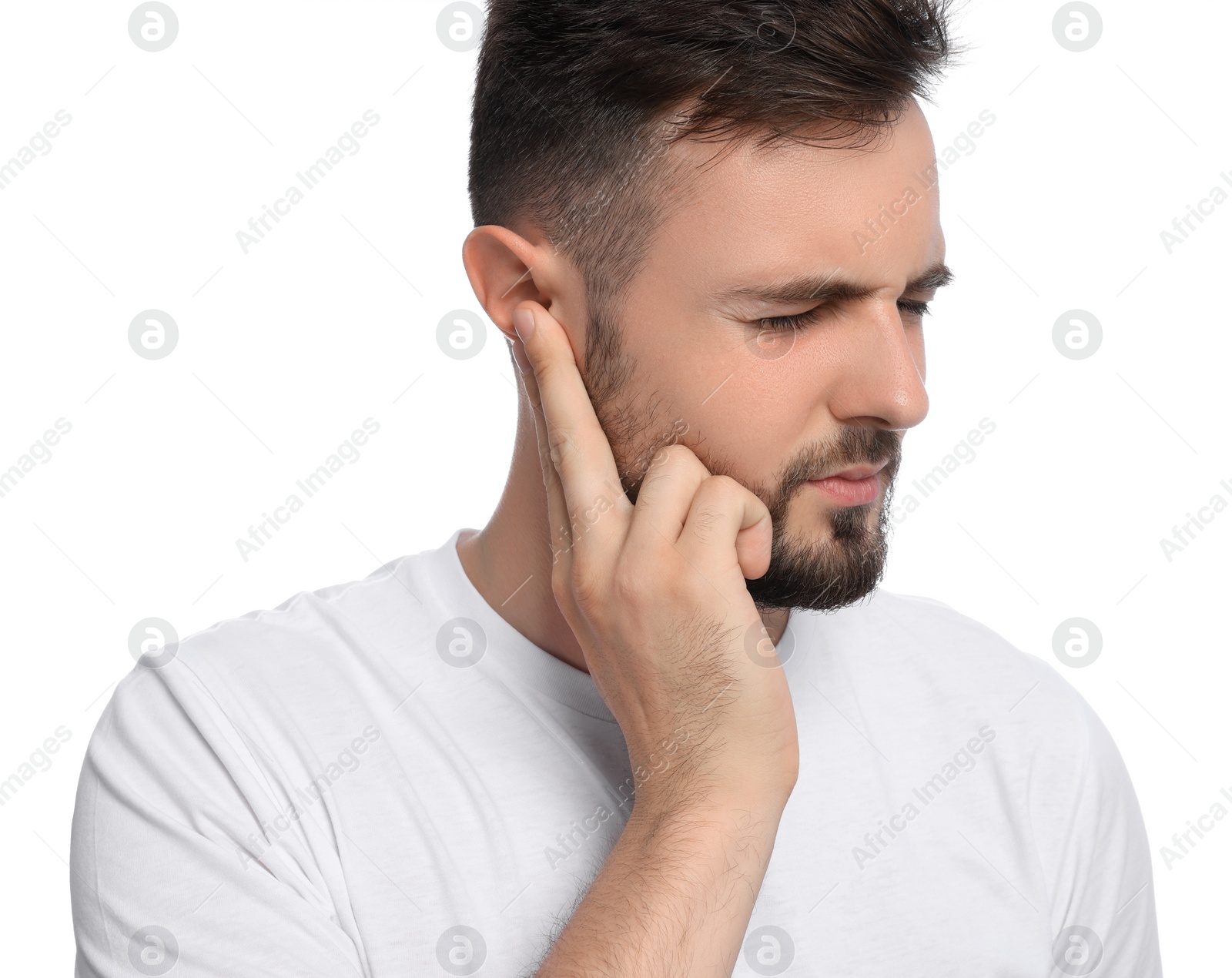 Photo of Young man suffering from ear pain on white background