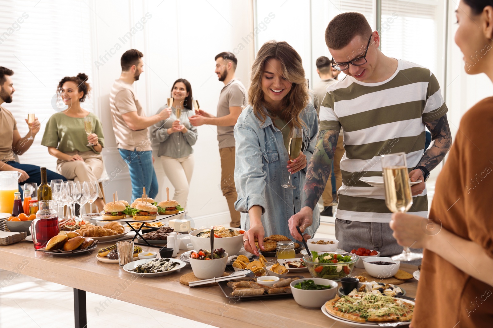 Photo of Group of people enjoying brunch buffet together indoors