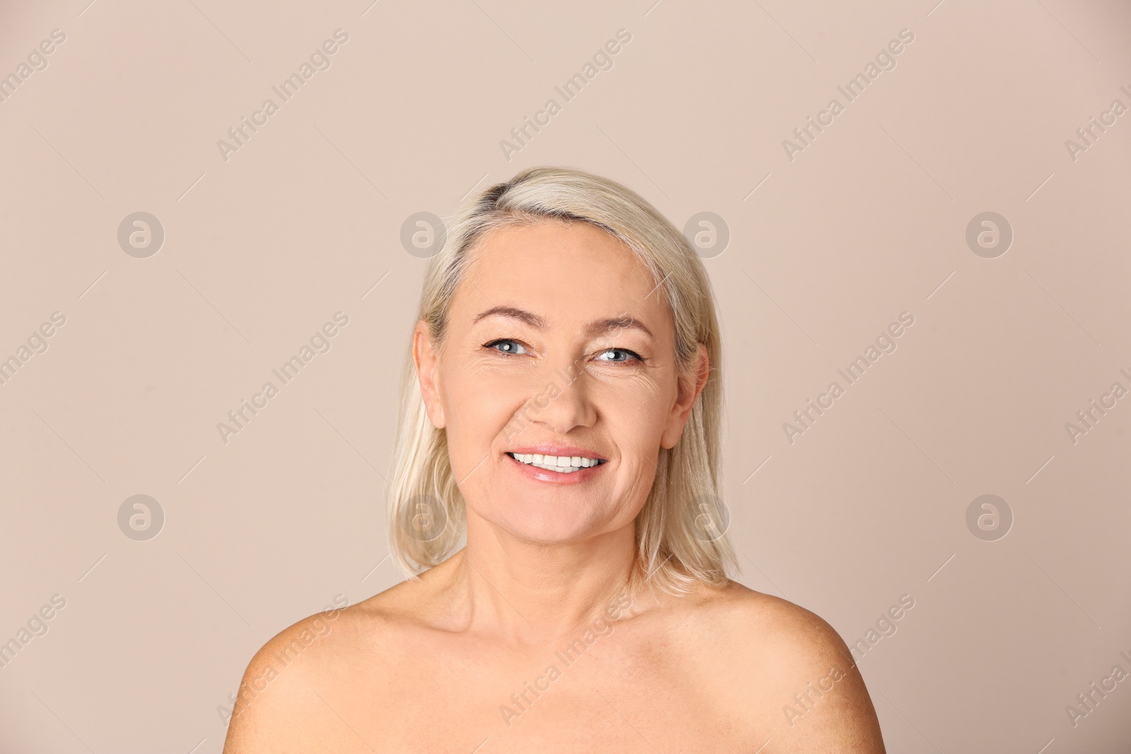 Photo of Portrait of beautiful mature woman on beige background