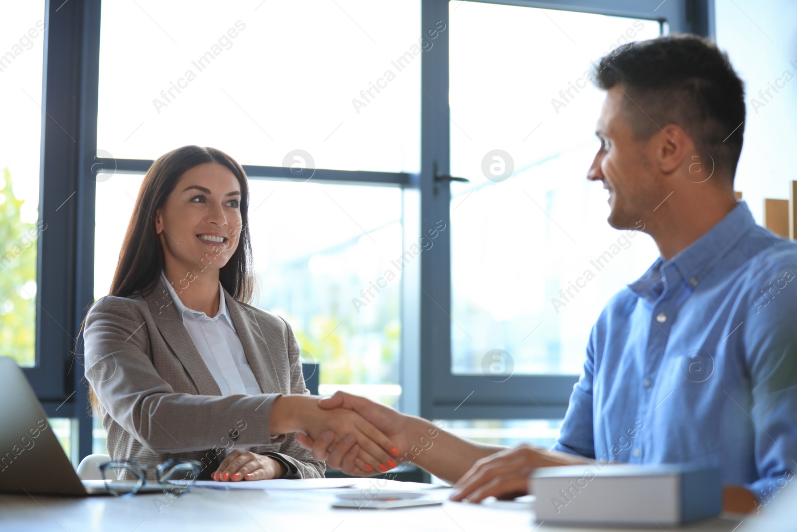 Photo of Female business trainer coaching young man in office