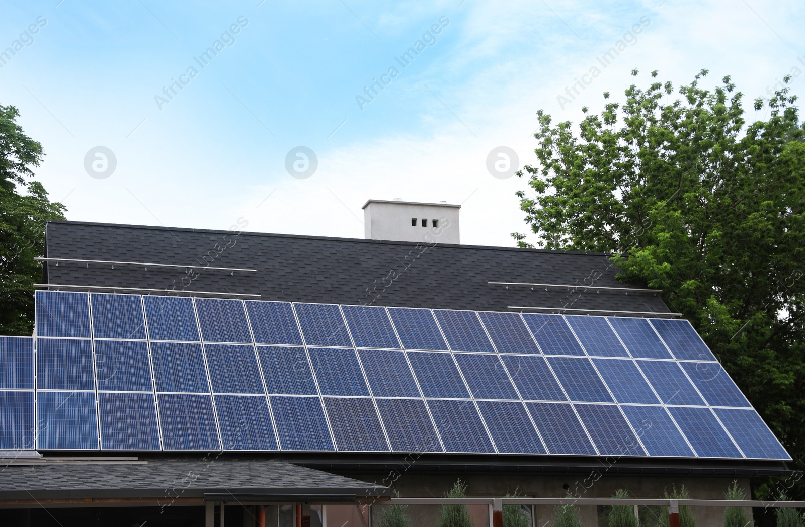 Photo of Building with installed solar panels on roof. Alternative energy source