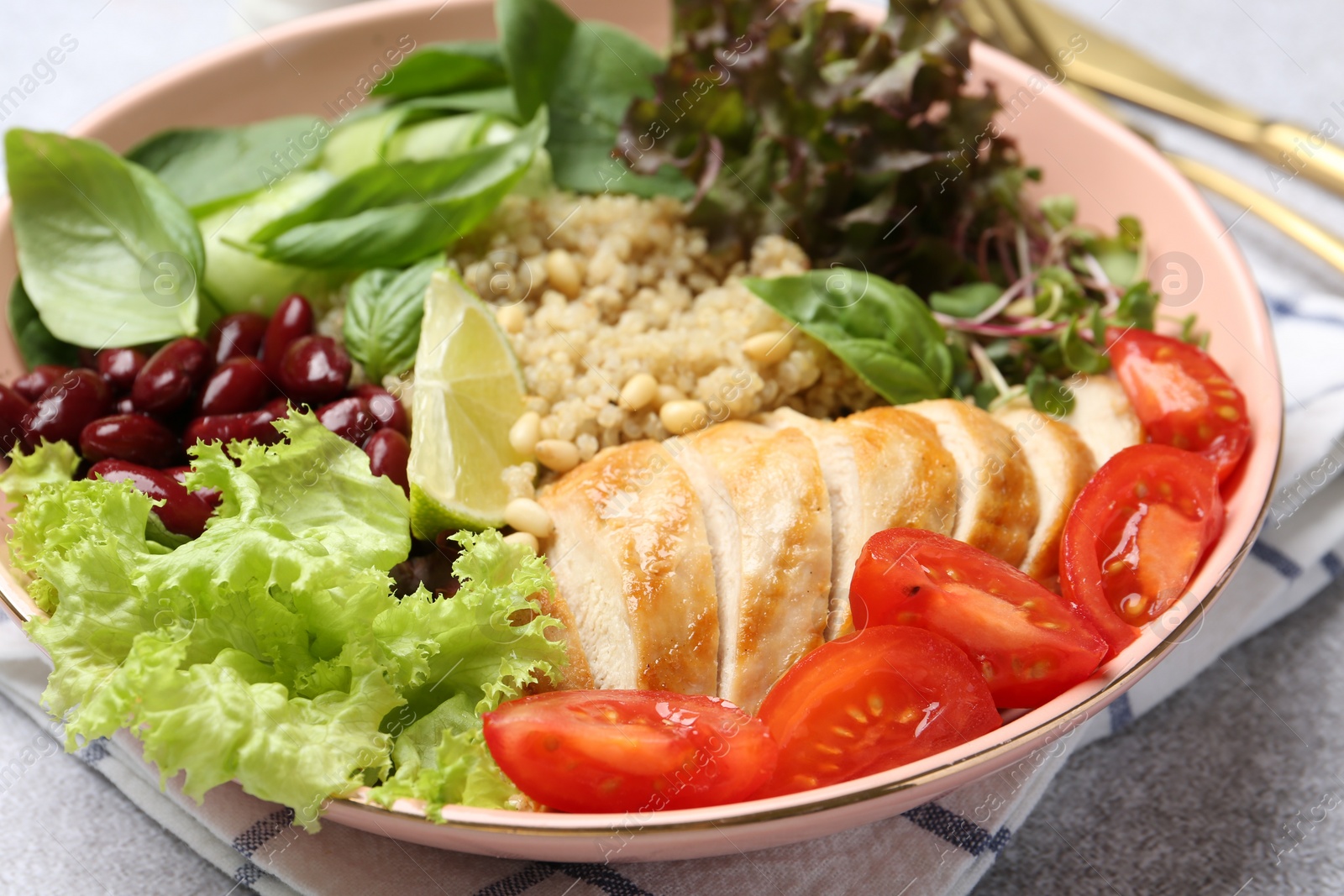 Photo of Healthy meal. Tasty vegetables, quinoa and chicken breast in bowl on white table, closeup