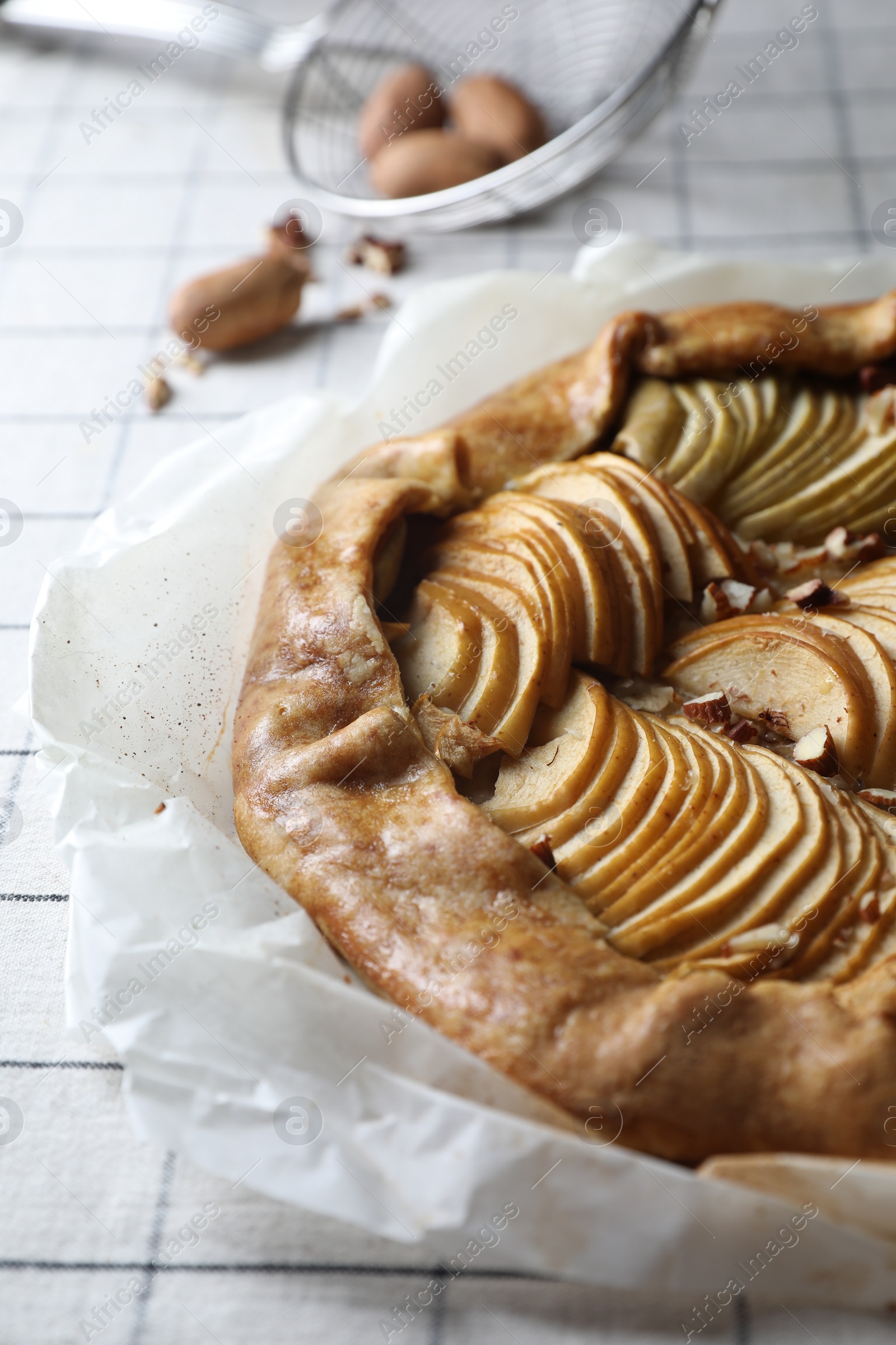 Photo of Delicious apple galette with pecans on table, closeup