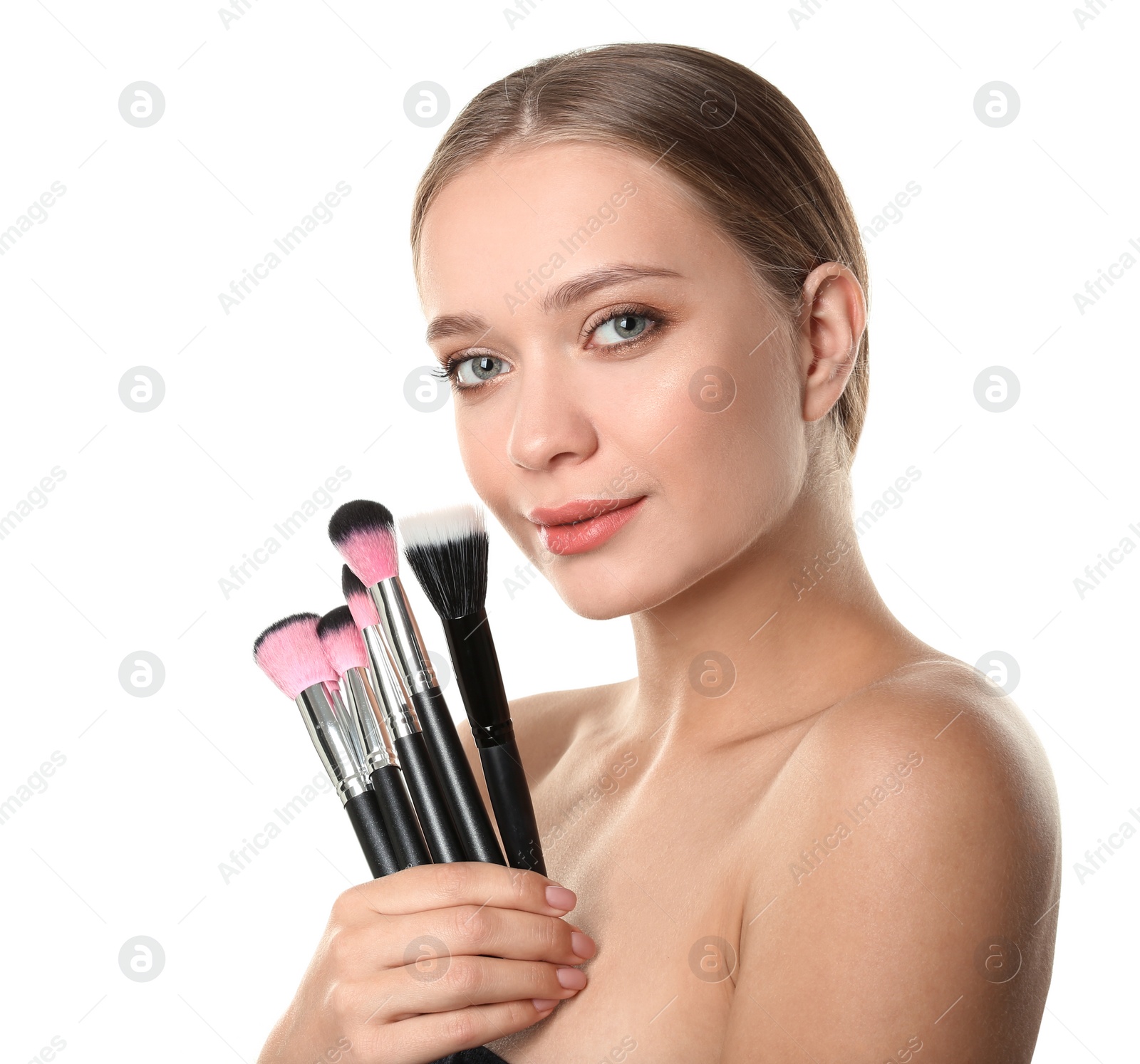 Photo of Portrait of beautiful young woman with makeup brushes on white background