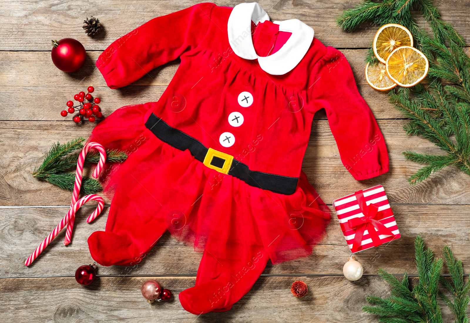 Photo of Flat lay composition with Christmas baby clothes on wooden background