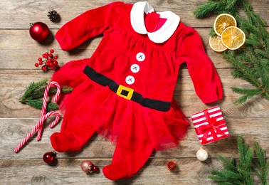 Photo of Flat lay composition with Christmas baby clothes on wooden background