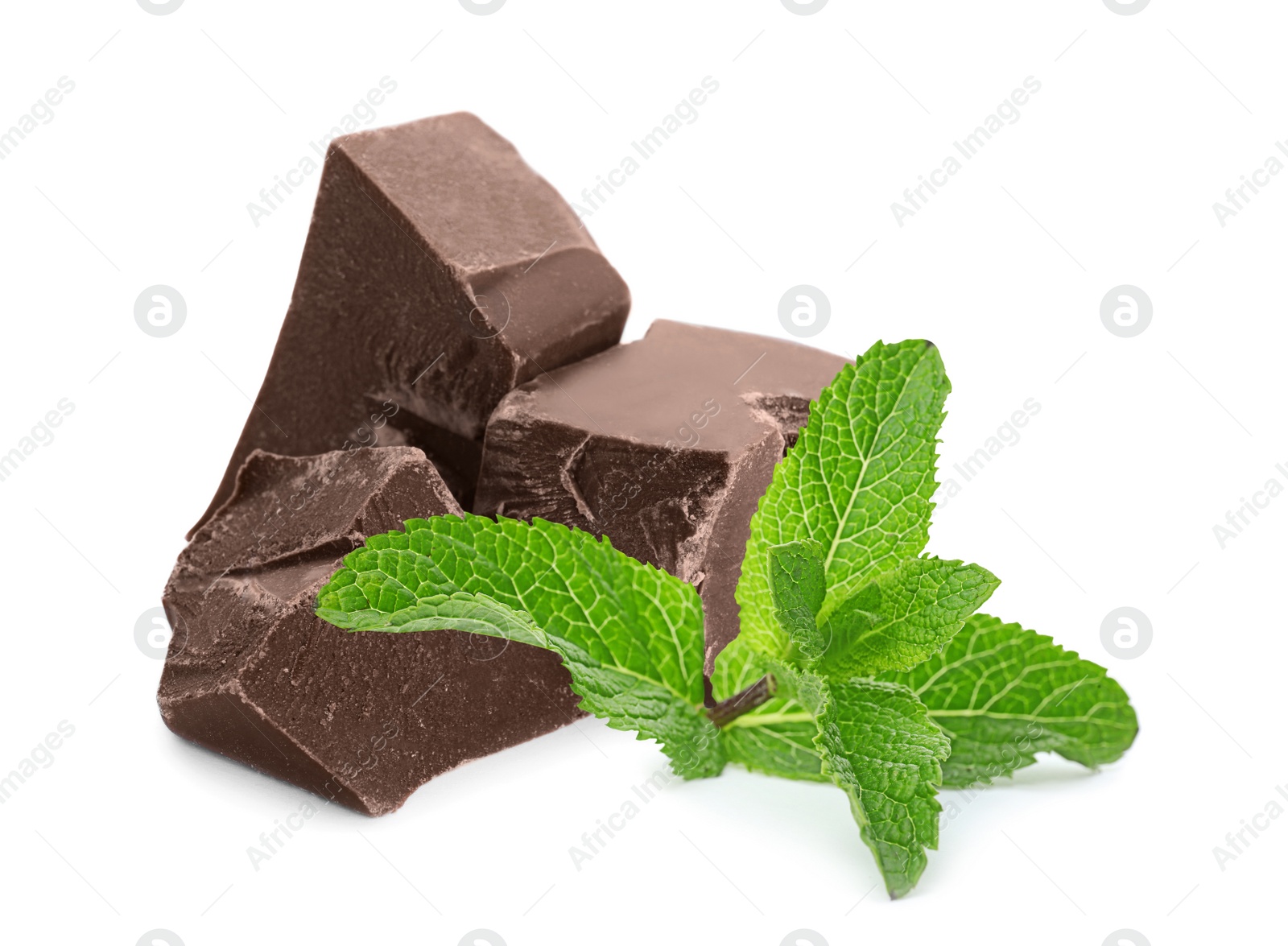 Image of Tasty milk chocolate pieces and mint on white background