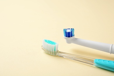 Manual and electric toothbrushes on color background. Dental care