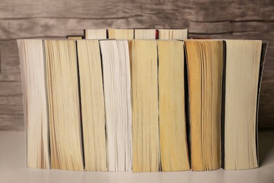 Photo of Collection of different books on white shelf